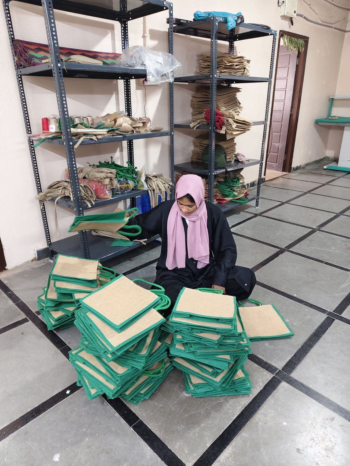 HuskWorks team member finishing and sorting handmade jute bags at the Hyderabad workshop