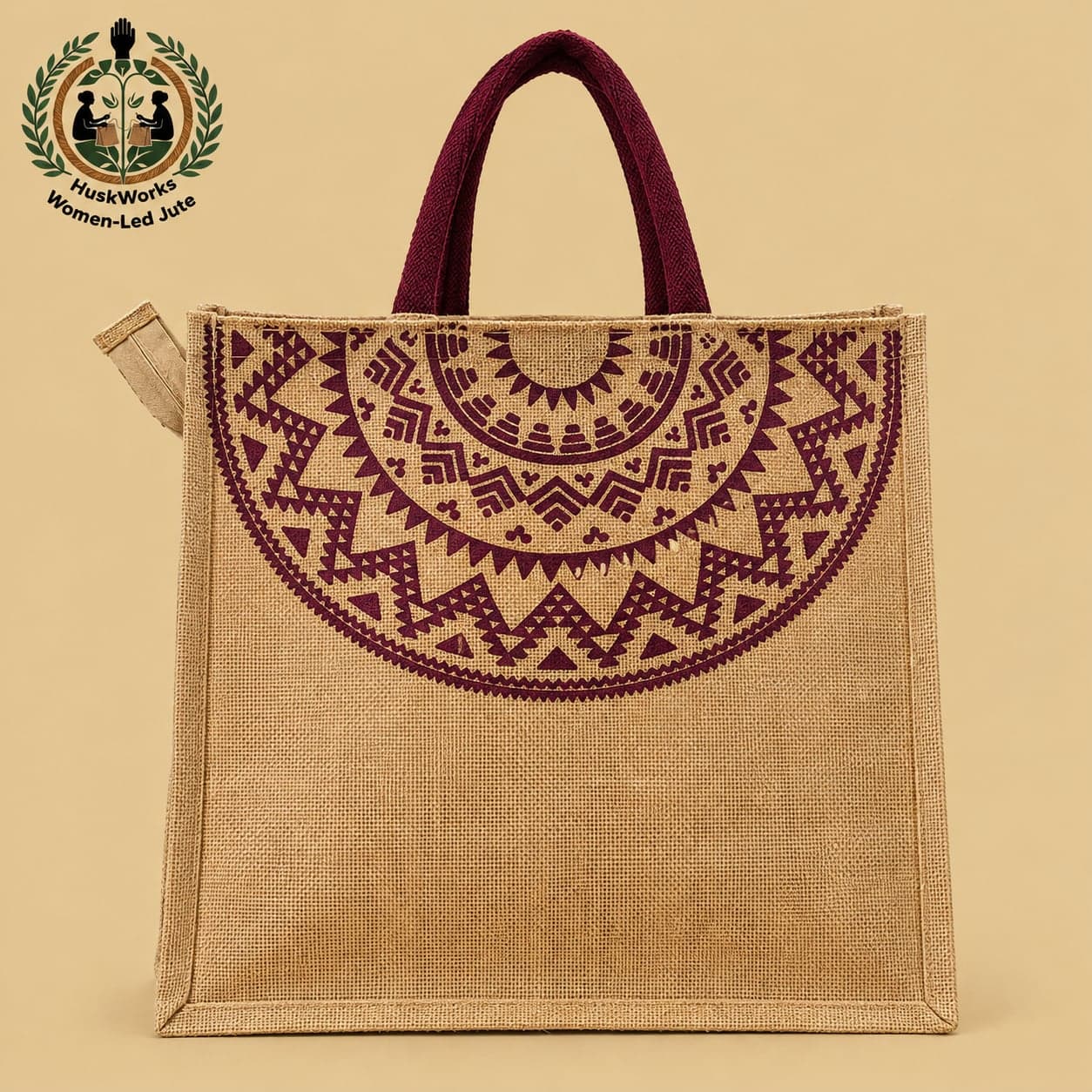Jute Shopping Tote by HuskWorks, 14" x 14", with maroon handles and a maroon printed design